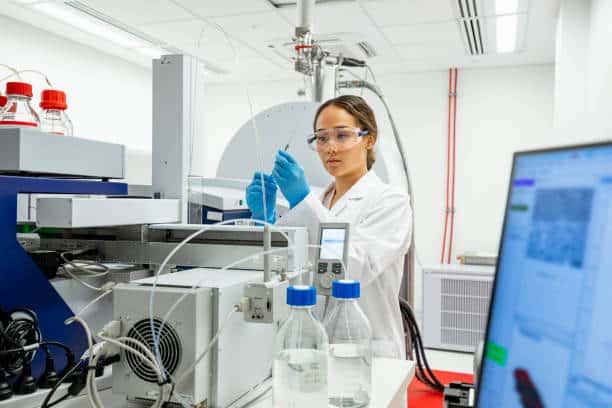 Image of a scientist operating a mass spectrometer
